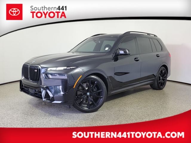 2024 BMW X7 M60i in Black Sapphire Metallic — front three-quarter view