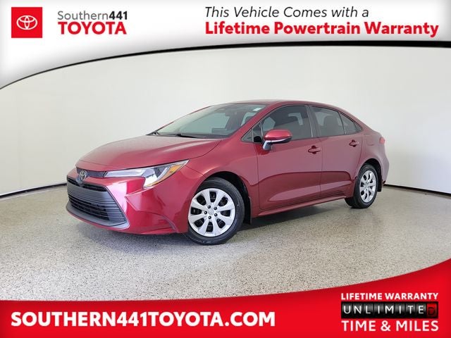 2024 Toyota Corolla LE in Ruby Flare Pearl — front three-quarter view