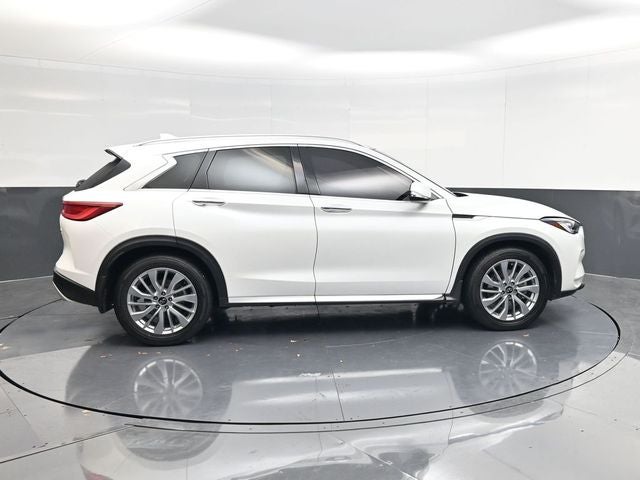 2023 INFINITI QX50 LUXE in White — front three-quarter view